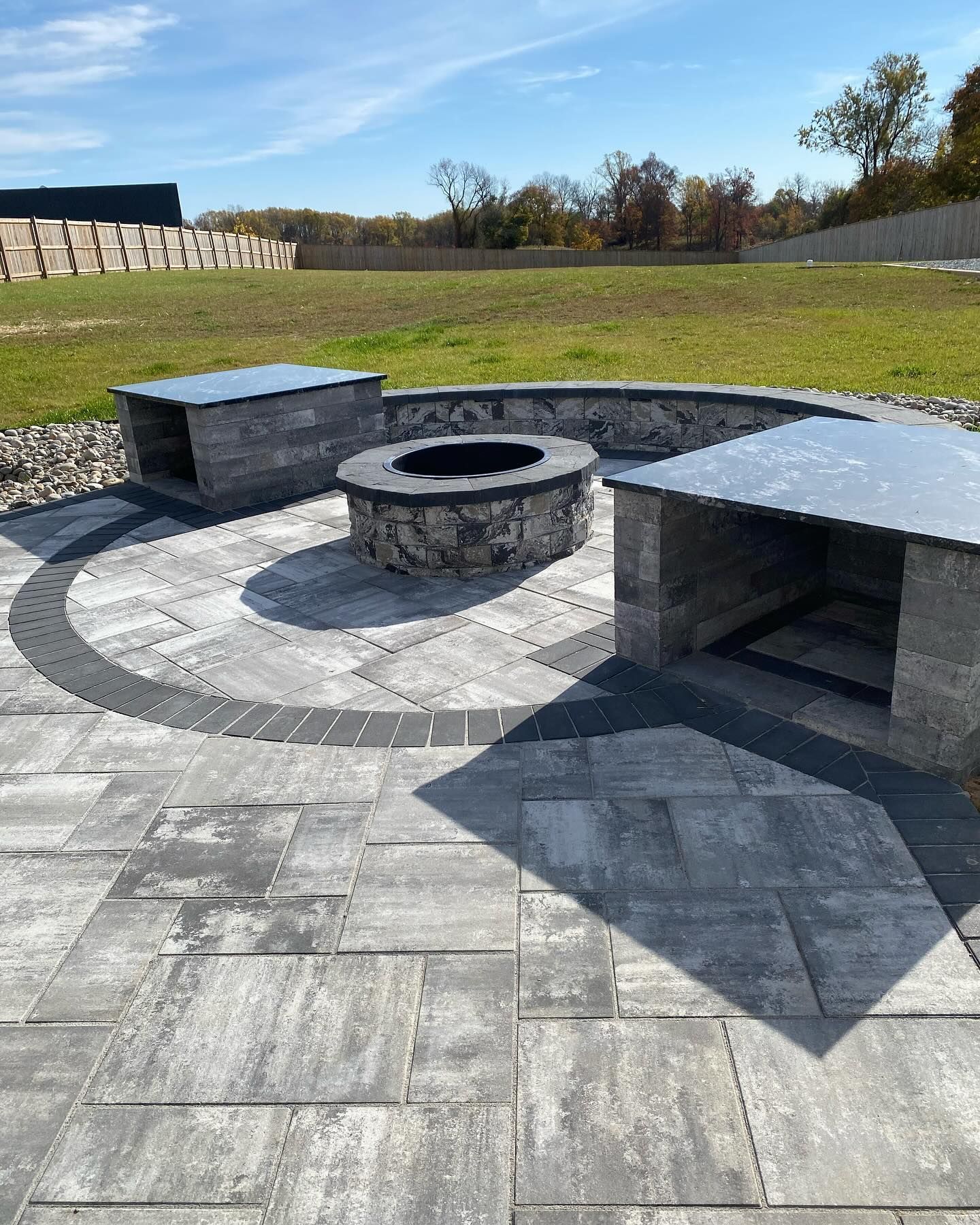 There is a fire pit in the middle of the patio.