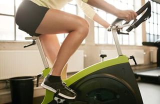 Woman in exercise bike—Multi-function and universal gym in Henderson, NV
