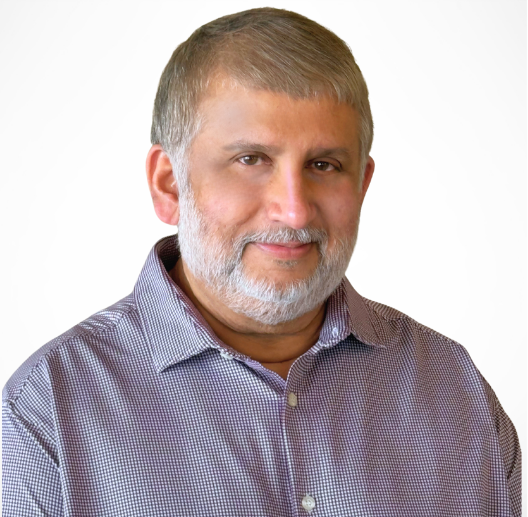 A man with a beard is wearing a plaid shirt