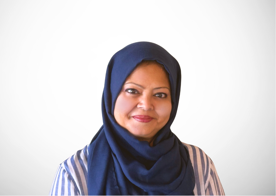 A woman wearing a blue hijab is smiling for the camera