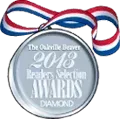 A silver medal with a red , white and blue ribbon on a white background.