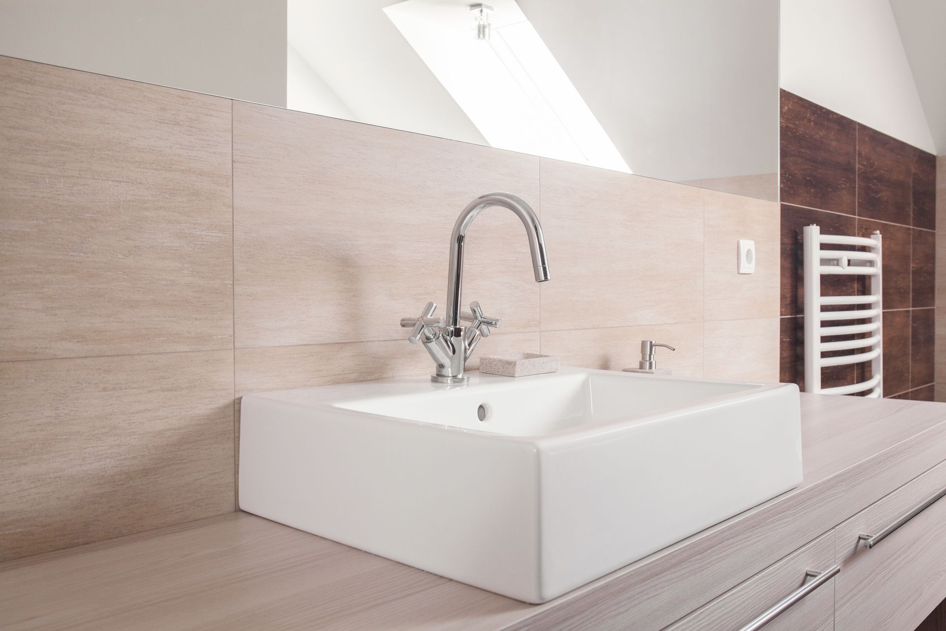 A bathroom sink with a faucet and a towel rack.