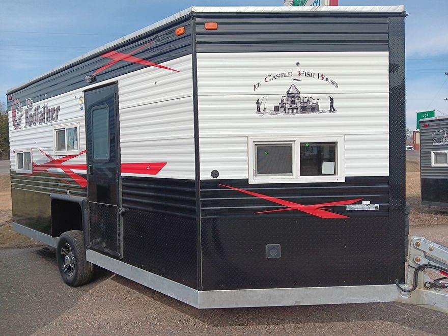 Ice fishing trailer, black and white exterior with red accents, logo on side.