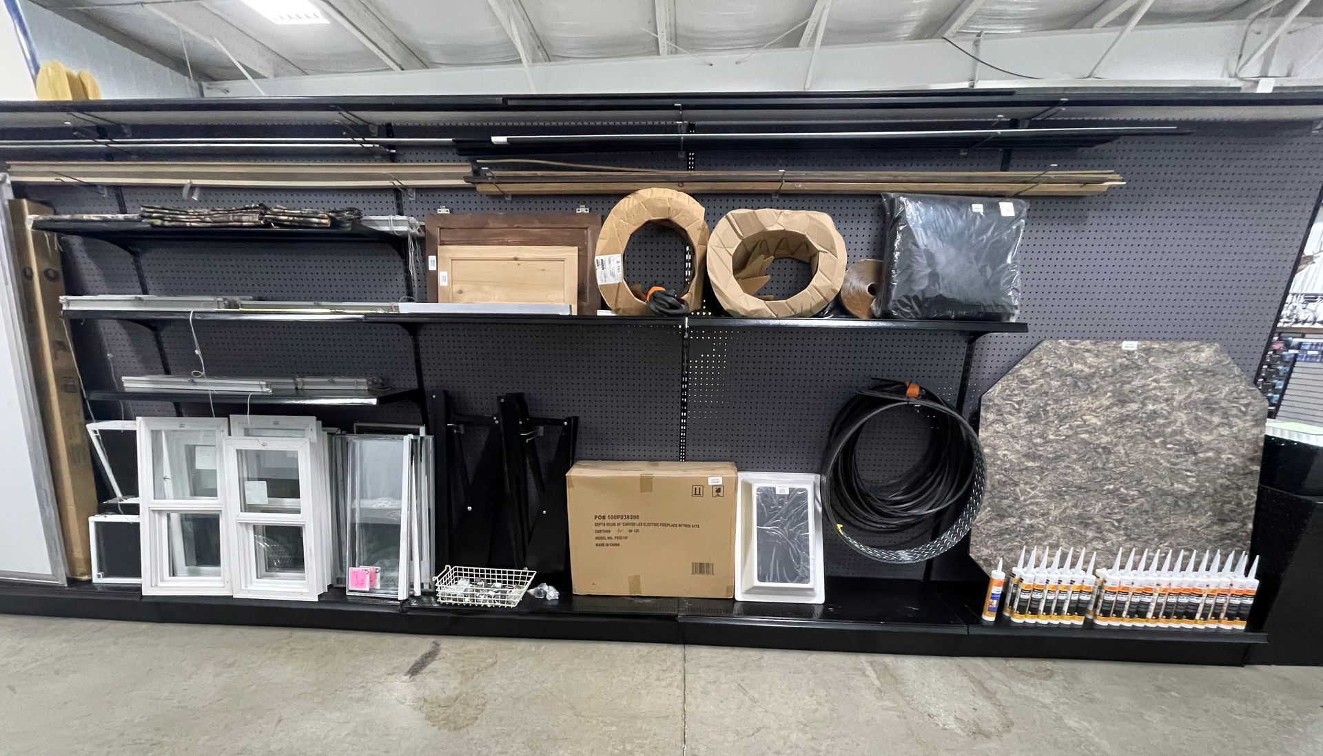 Gray and black enclosed trailer with a white door, parked outdoors.