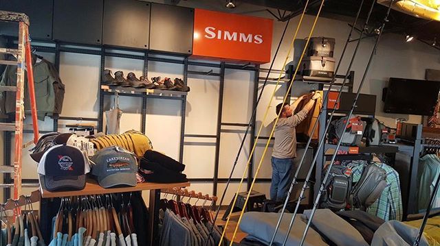 A man is working on a simms sign in a store