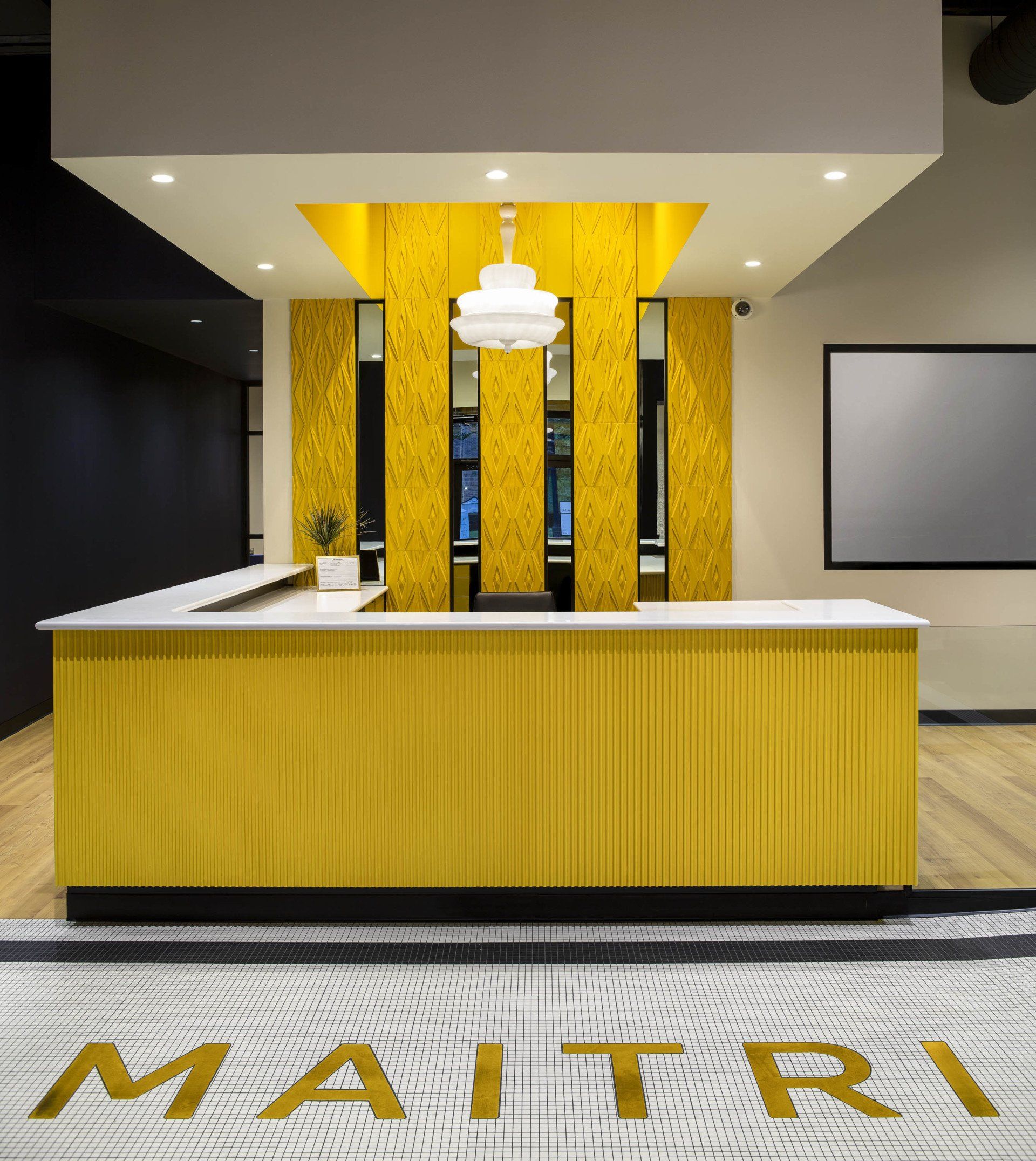 A yellow counter in a room with the word maitri on the floor