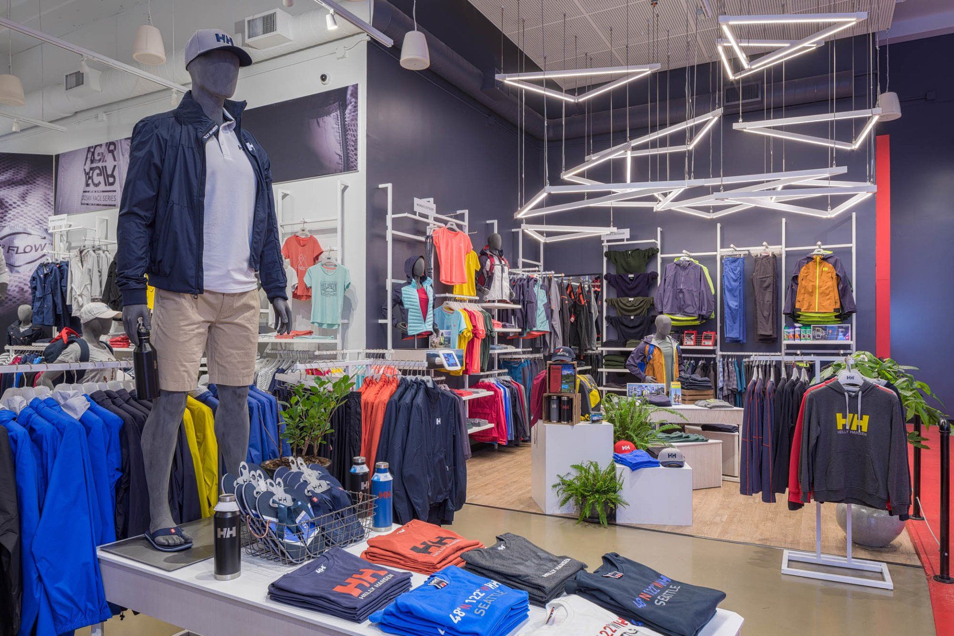 A store filled with lots of clothes and a mannequin.