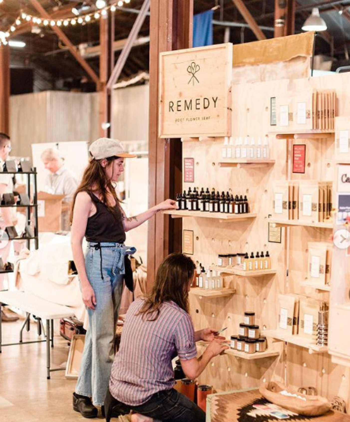 A man is kneeling down in front of a sign that says remedy