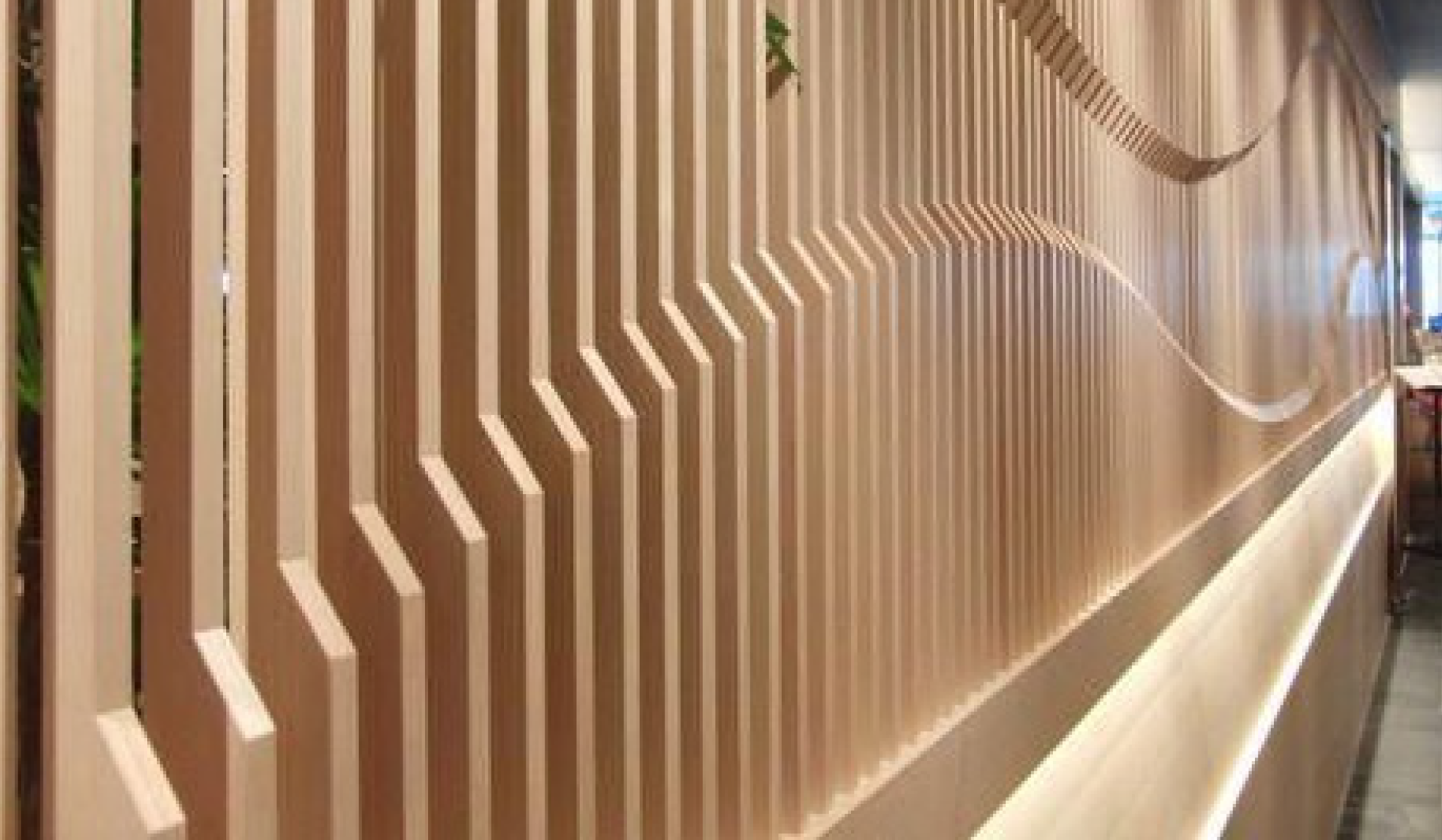 A wooden wall in a restaurant with a sculpture on it.