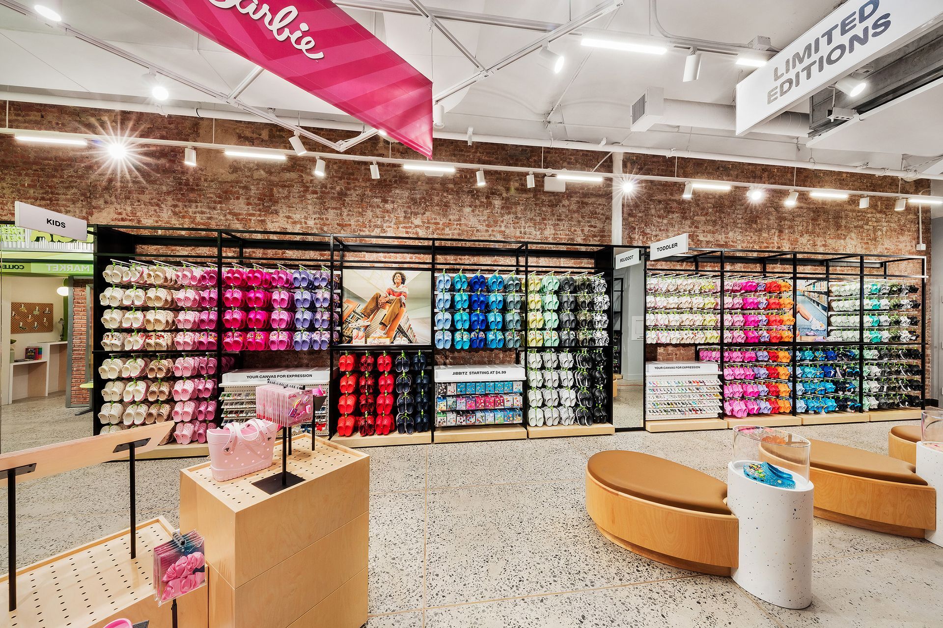 Interior of a retail store displaying colorful shoes, with 
