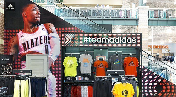 A basketball player is hanging on a wall in a store.