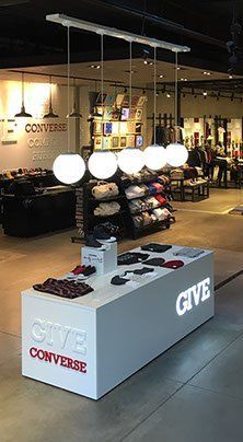 A converse store with a counter in the middle of the store.