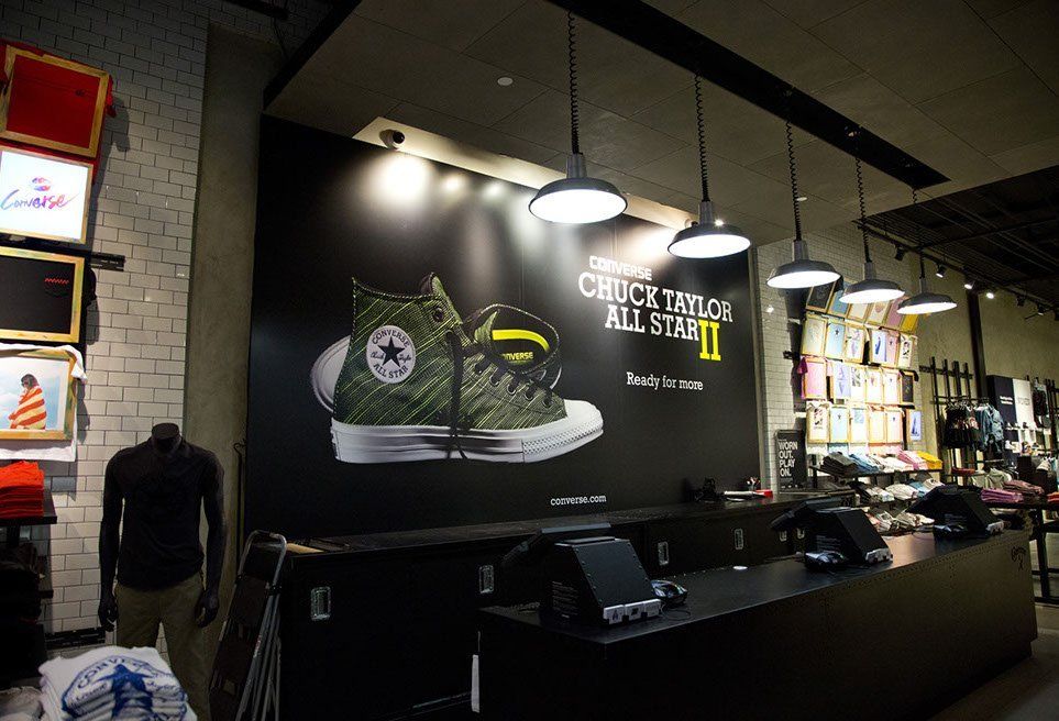 A converse store with a large sign on the wall