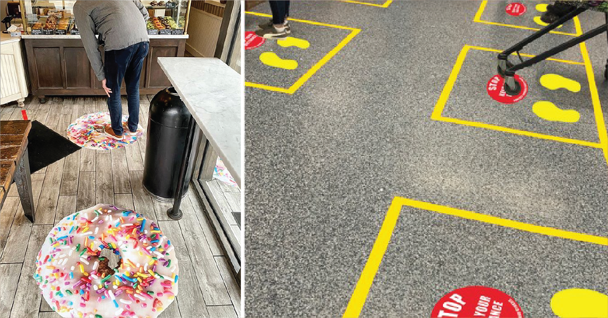 A person is standing on a table next to a donut on the floor.