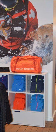 A shelf with a bag on top of it that says helly hansen