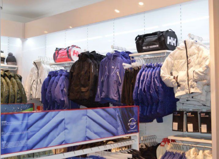 A store filled with clothes and a bag that says hh