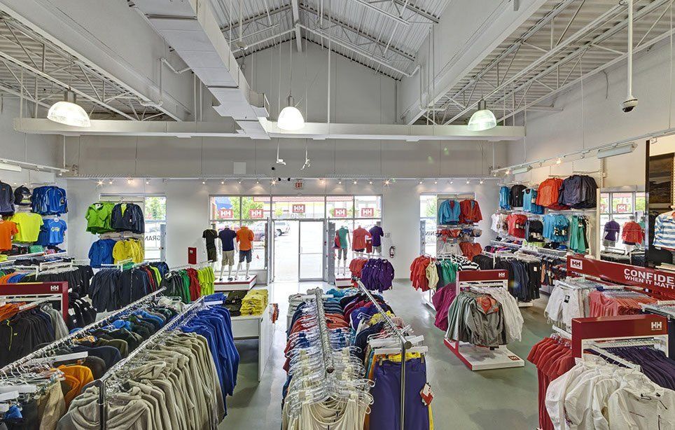 The inside of a clothing store filled with lots of clothes.