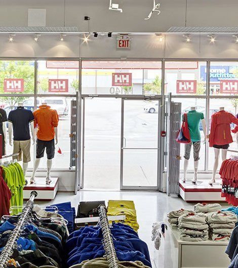 The inside of a clothing store with mannequins displaying clothes.