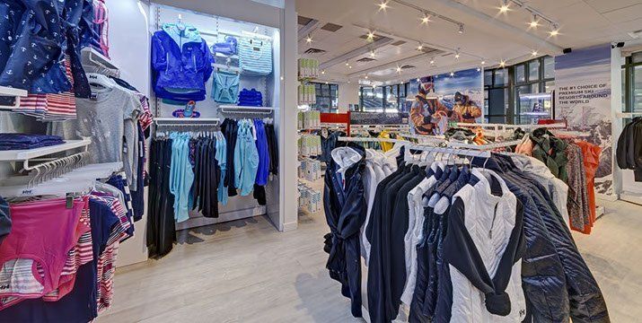 A clothing store filled with lots of clothes hanging on racks.