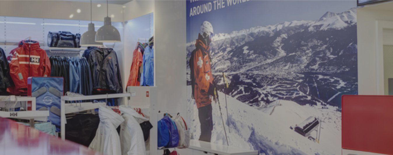 There is a picture of a person skiing on the wall of a store.