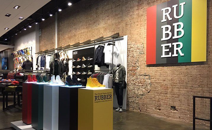 A store with a brick wall and a sign that says ru bb er.