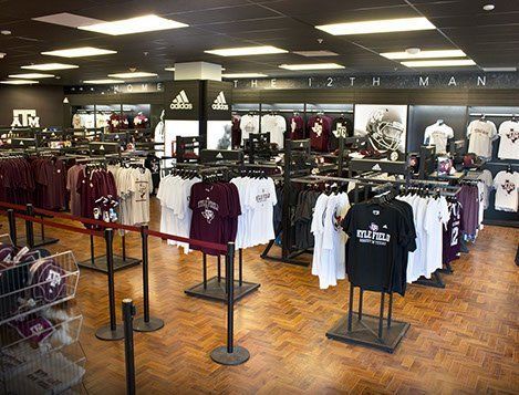 A store filled with lots of shirts and a sign that says adidas