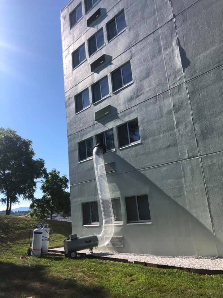 A large building with a hose coming out of it