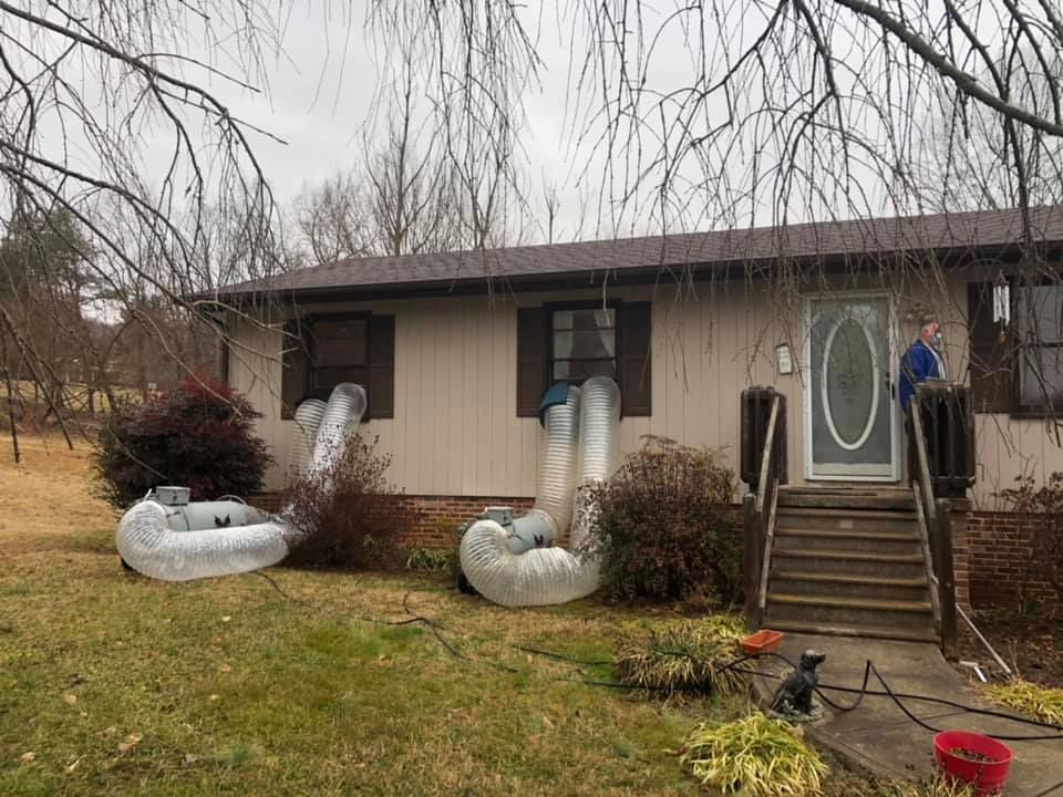 A house with a lot of inflatable rafts in front of it.