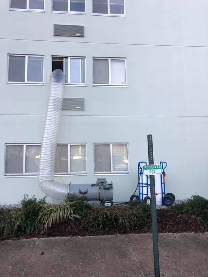 A building with a hose attached to the side of it