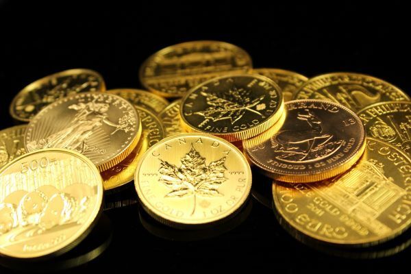 Gold bullion coins on a black background