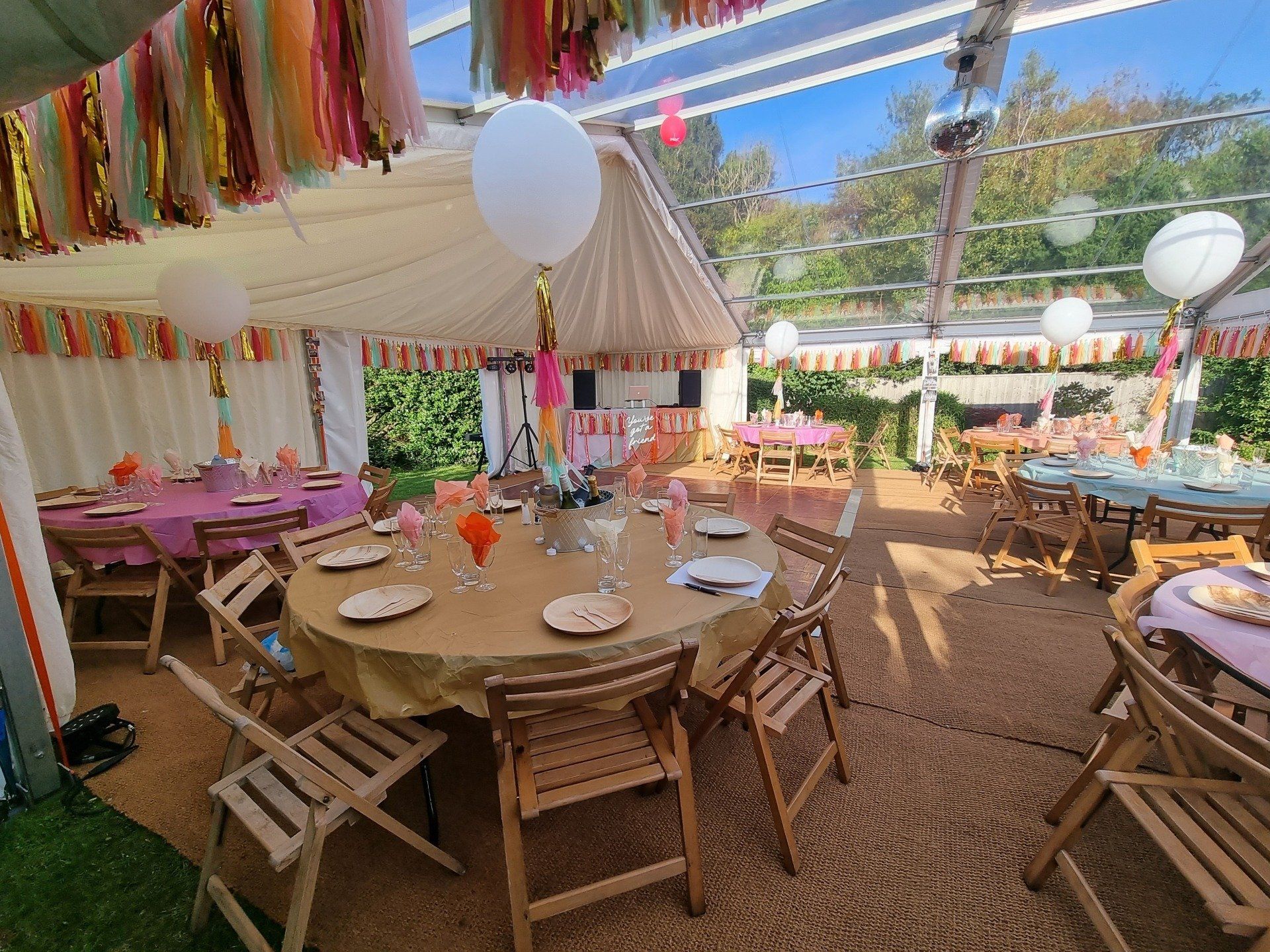 A large tent with tables and chairs set up for a party.