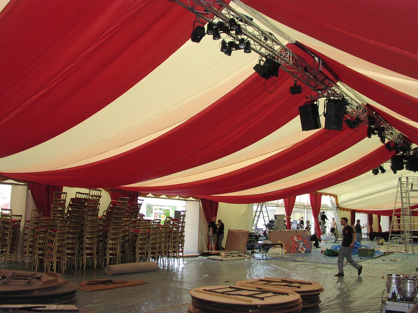 A large tent with red and white stripes on the ceiling