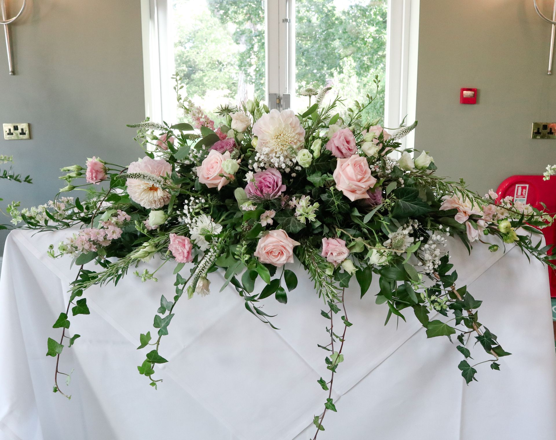 A table with a white table cloth and flowers on it