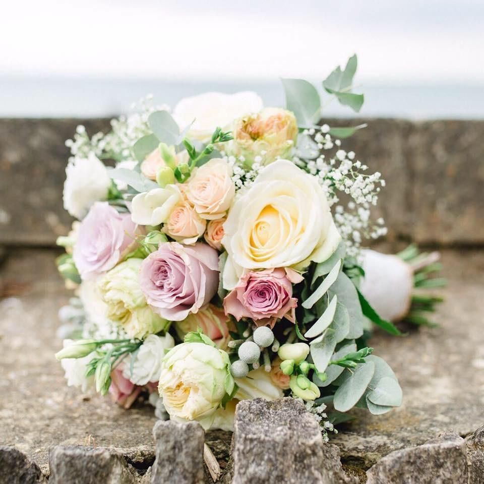 A bouquet of flowers is sitting on top of a rock.