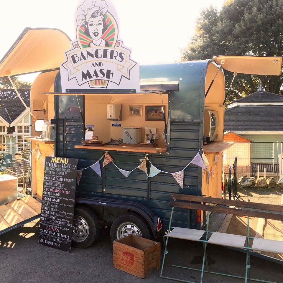 A food truck with a sign that says bangers and mash