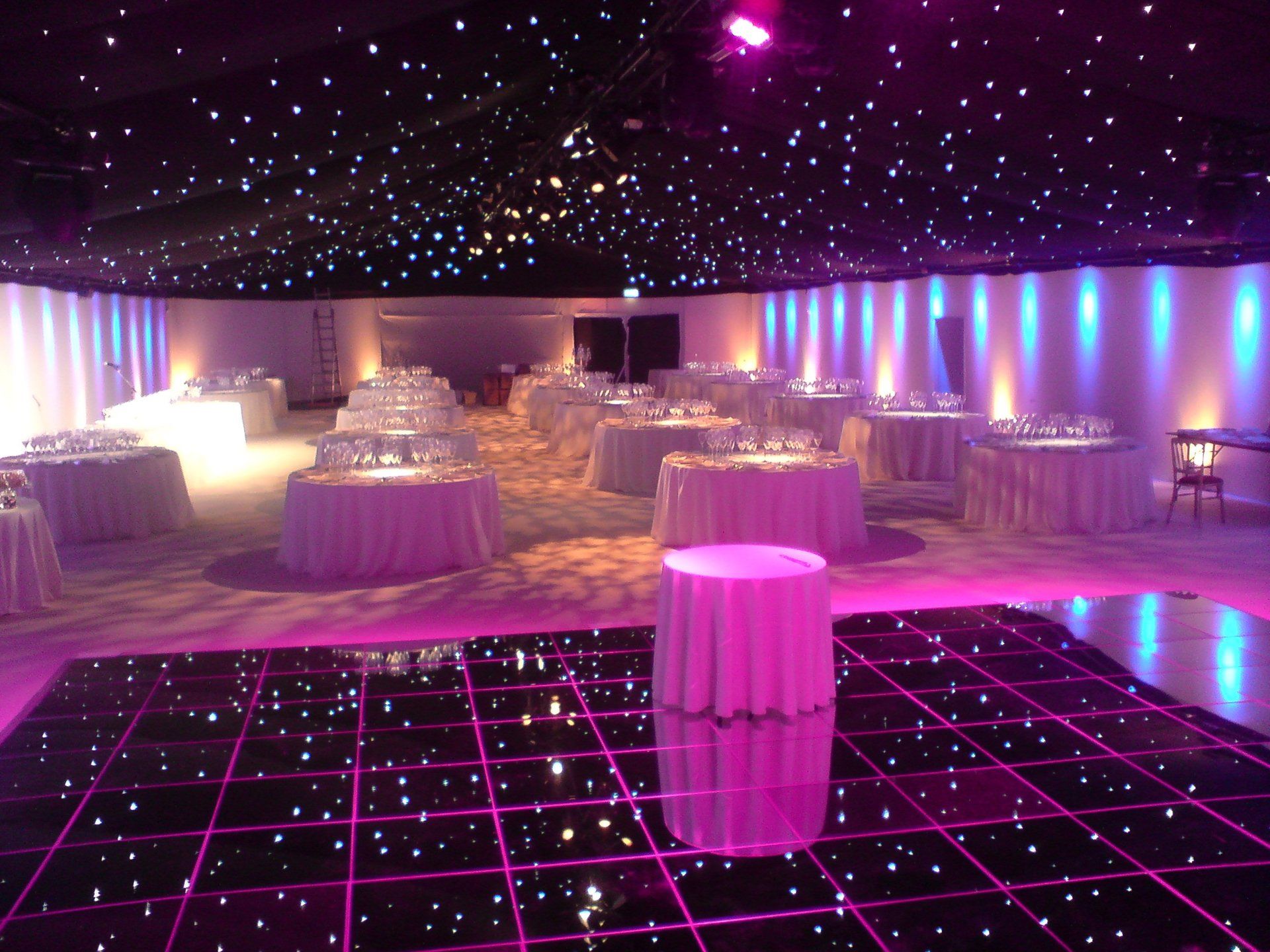 A large room with tables and a dance floor