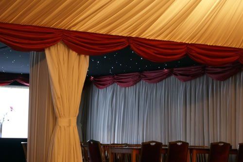 A room with tables and chairs under a tent