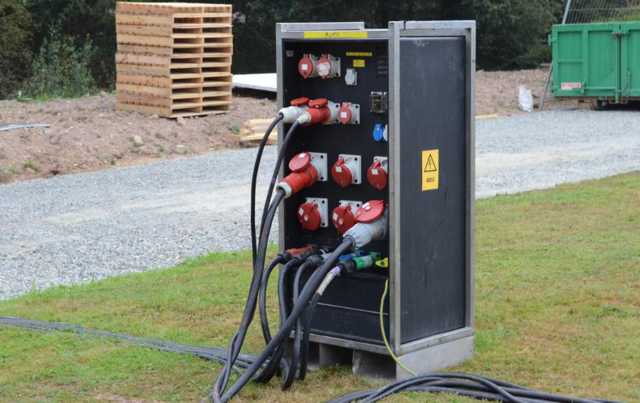 A black box with a bunch of wires plugged into it