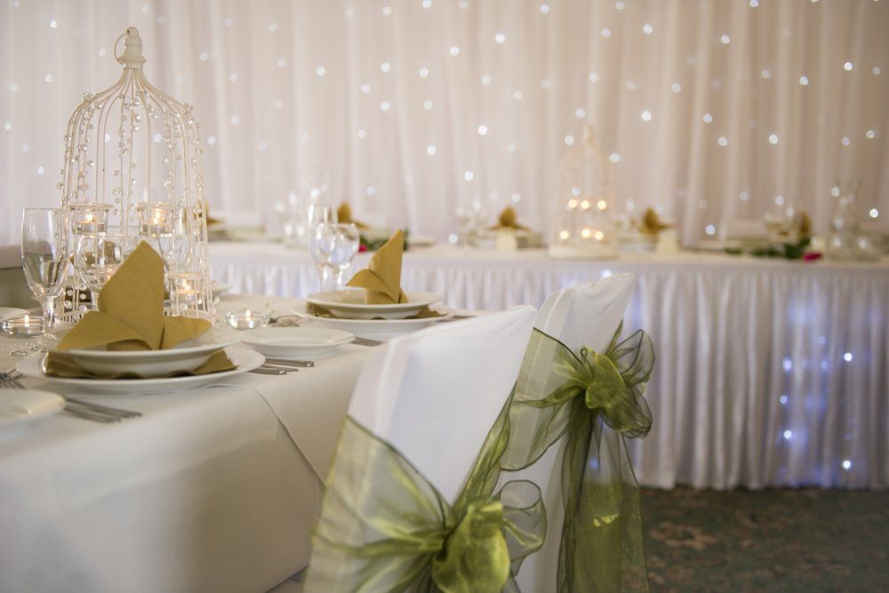 A table and chairs are set for a wedding reception.