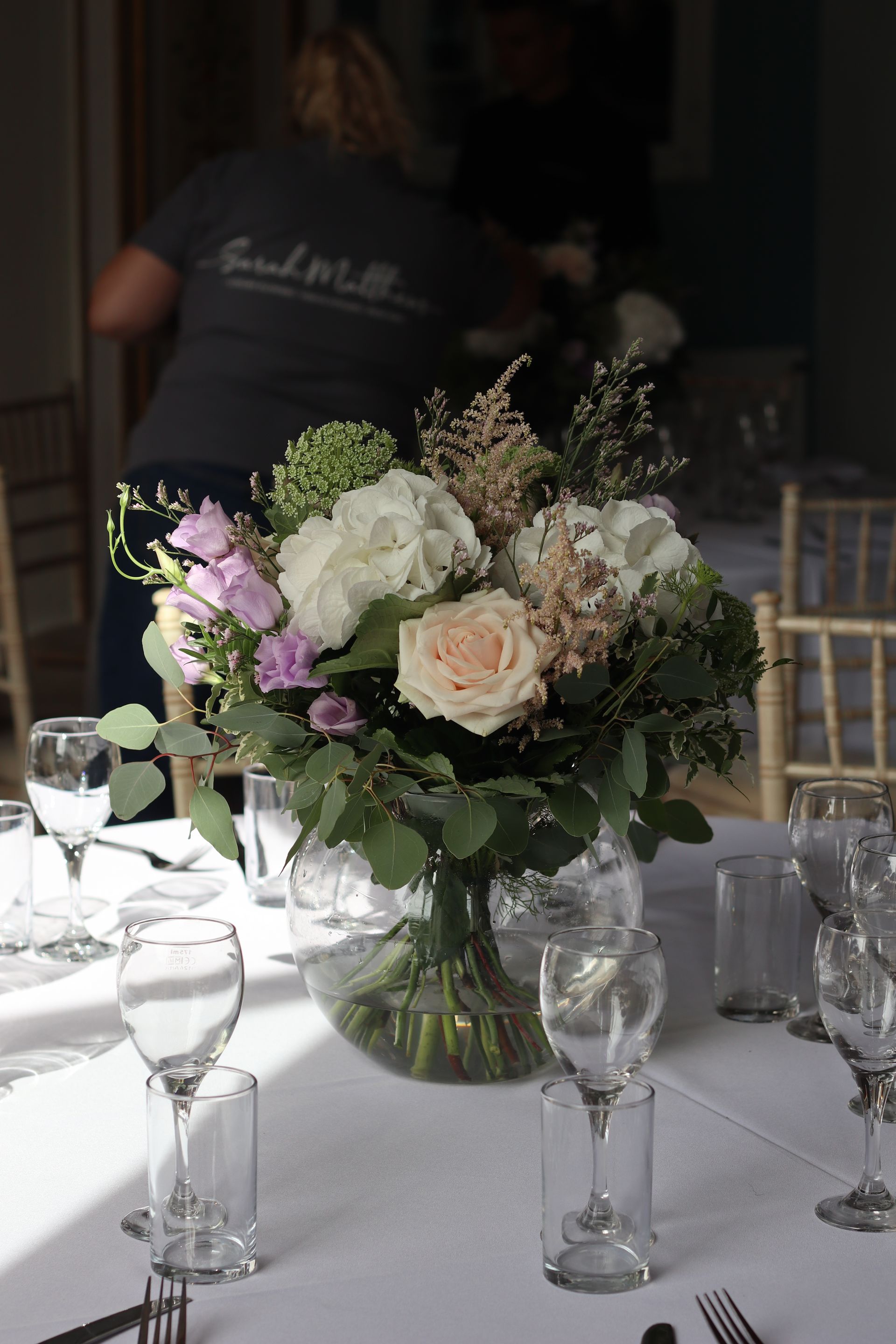 A vase filled with flowers is sitting on a table.