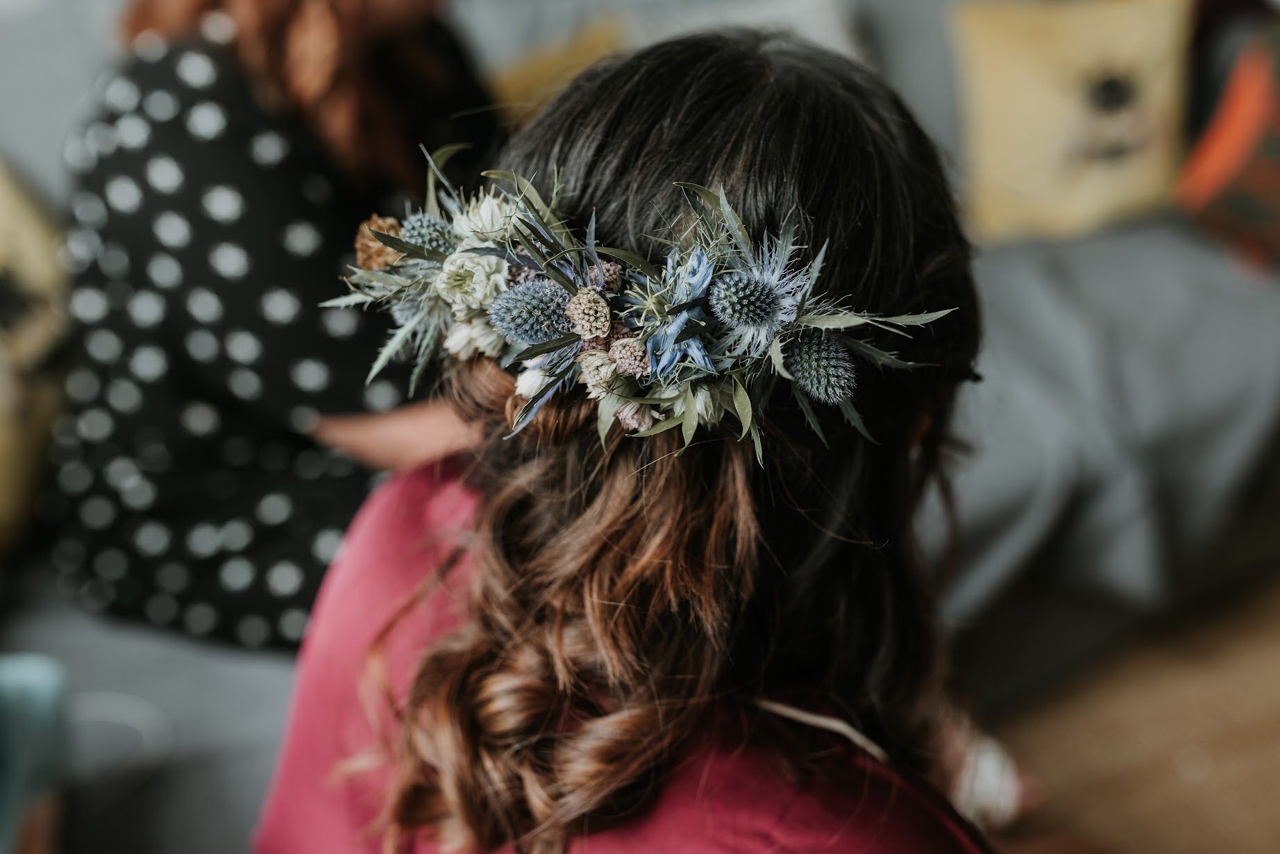 A woman is wearing a flower crown in her hair.