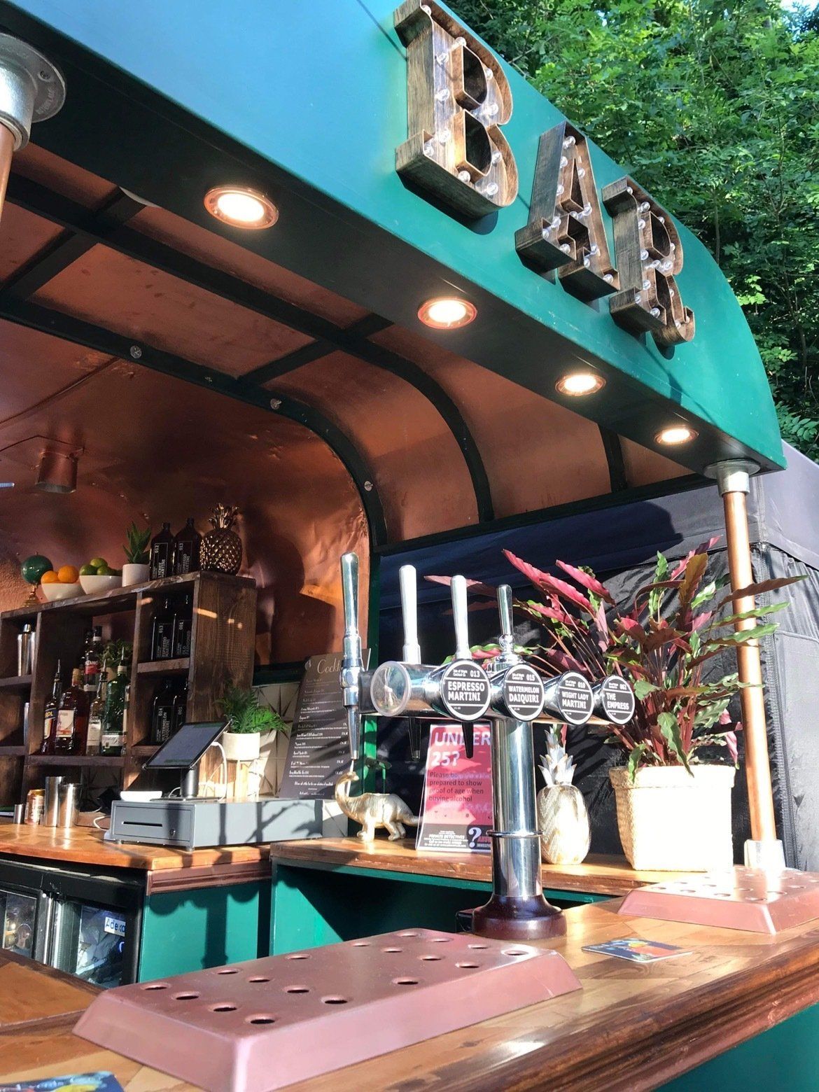 A bar with a green awning that says bar on it