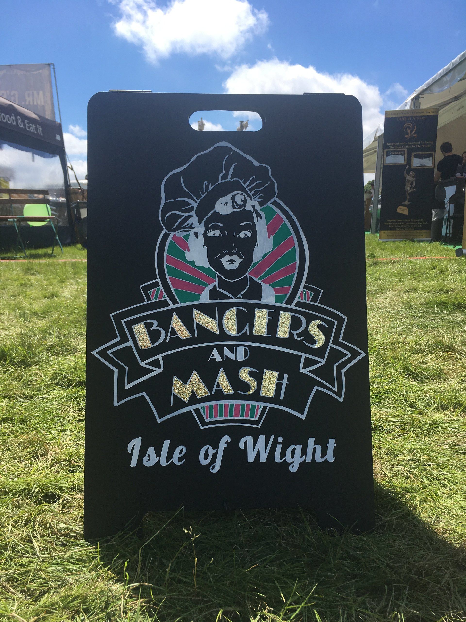 A chalkboard sign for bangers and mash isle of wight