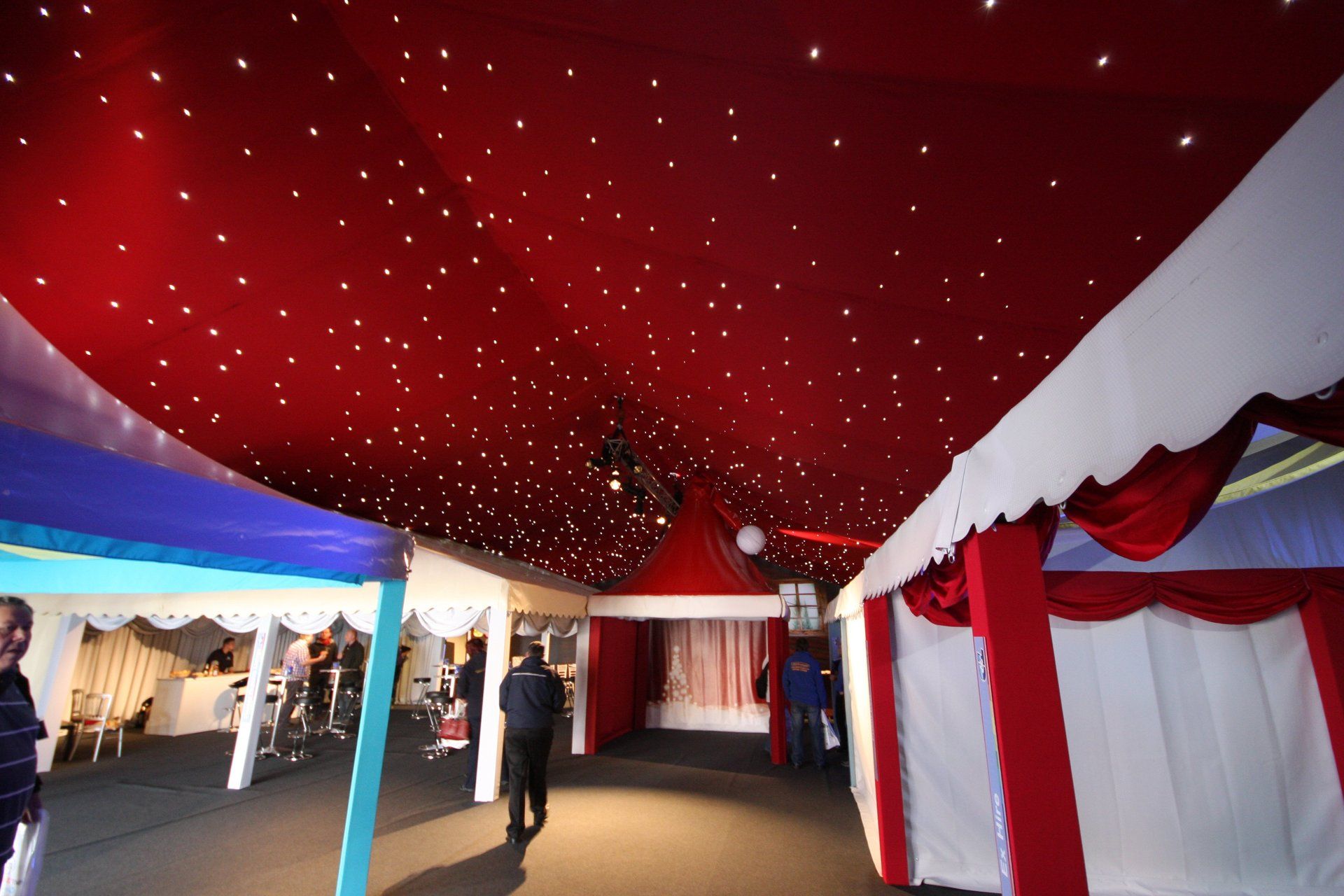 A red and white tent with a starry ceiling