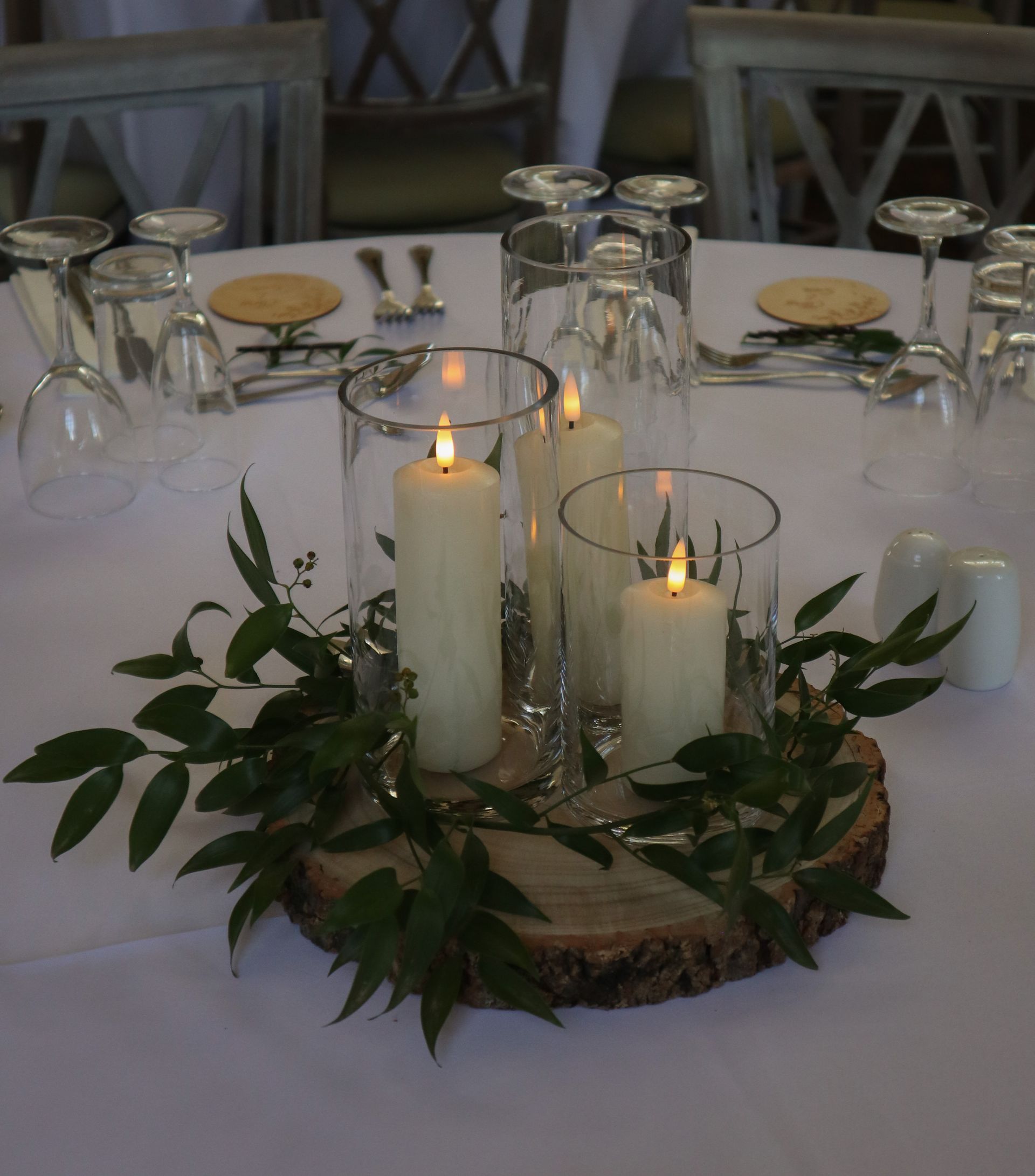 A table setting with candles and glasses on it