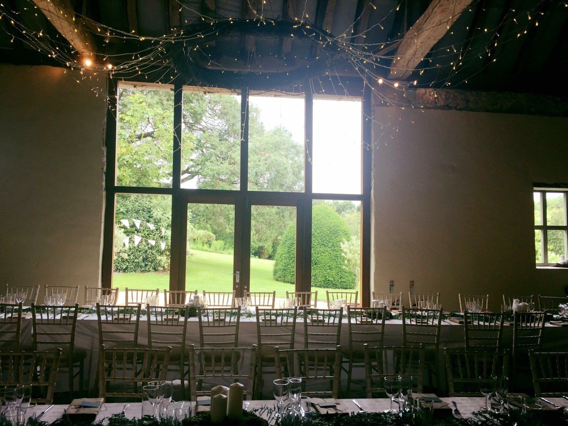 A long table and chairs in a room with a large window