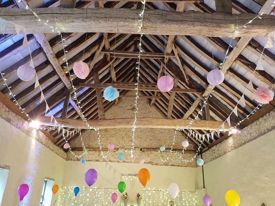 A room with balloons and lights hanging from the ceiling.