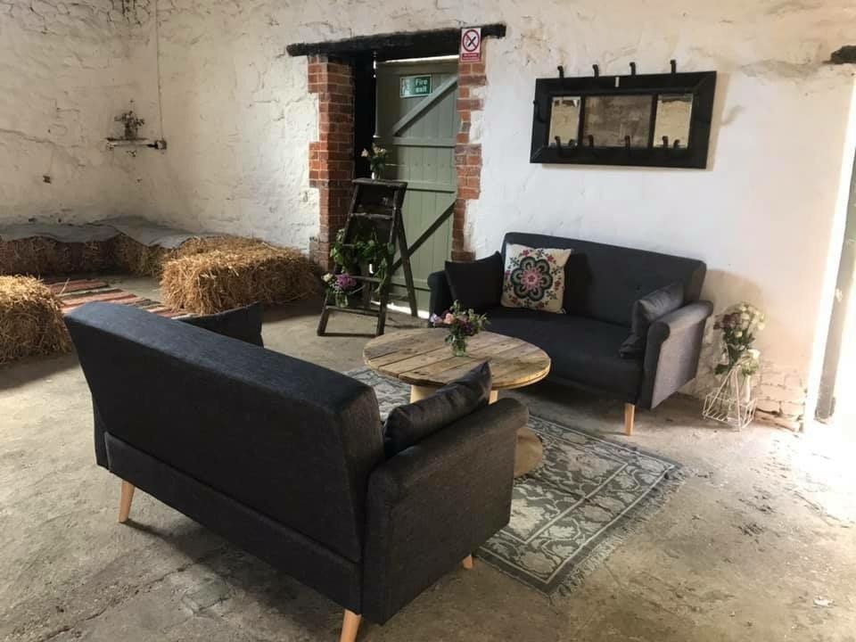 A living room filled with furniture and hay bales.