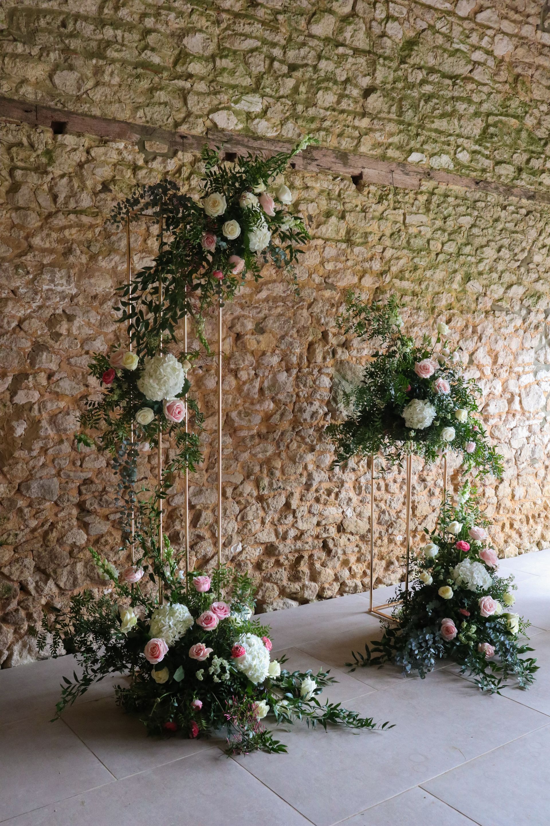 A brick wall with flowers on it in front of it.