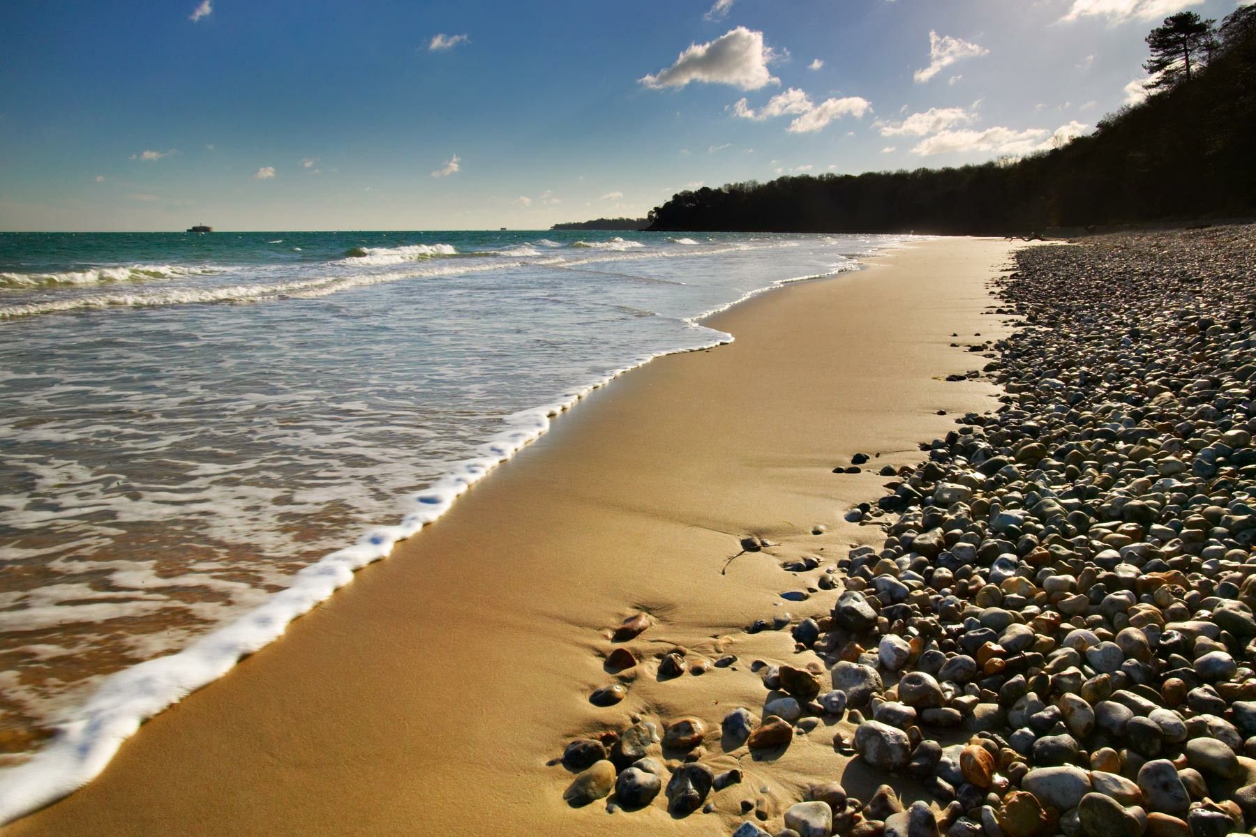 A beach with a lot of rocks and sand